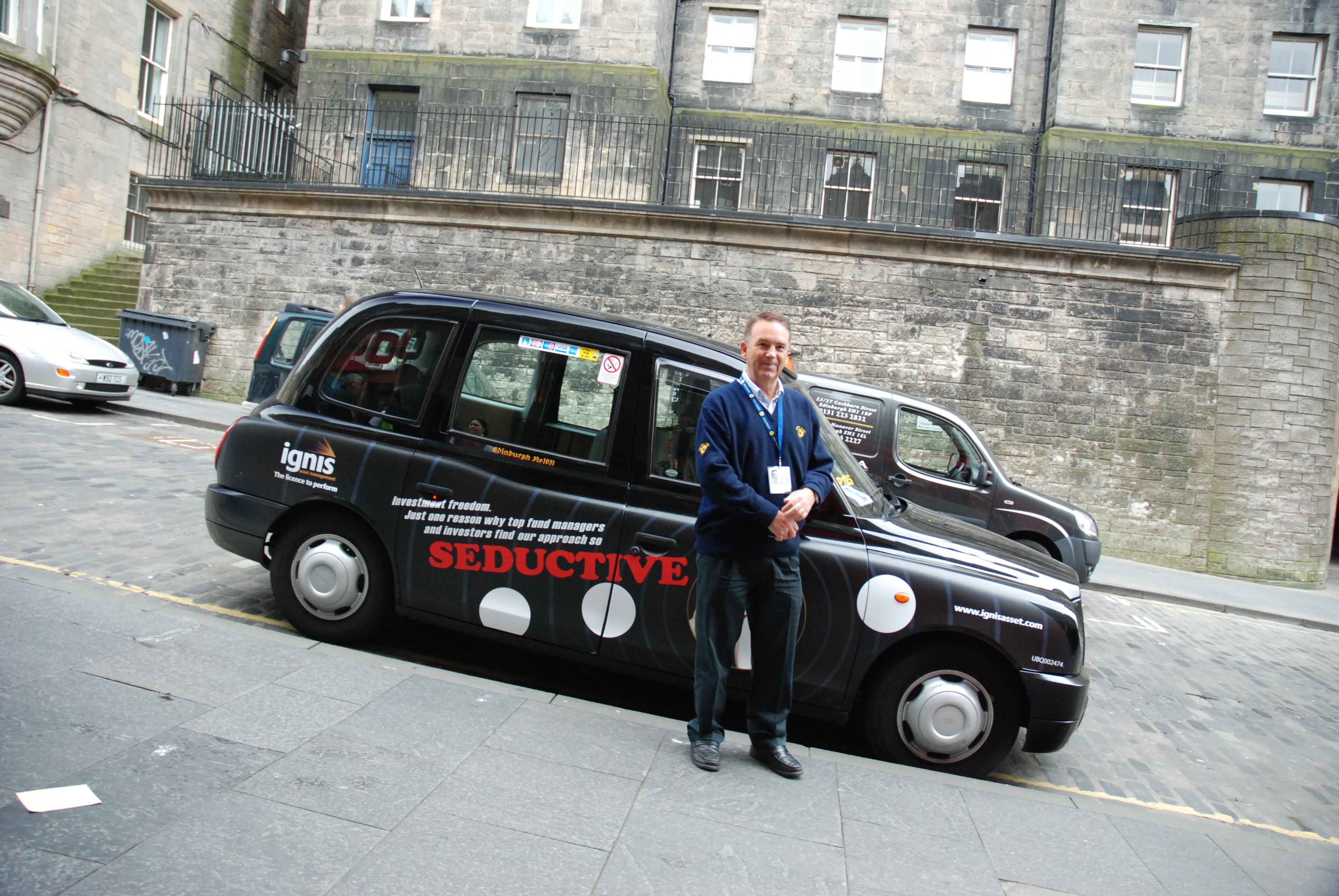 Edinburgh taxi driver Ian Tate standing beside his