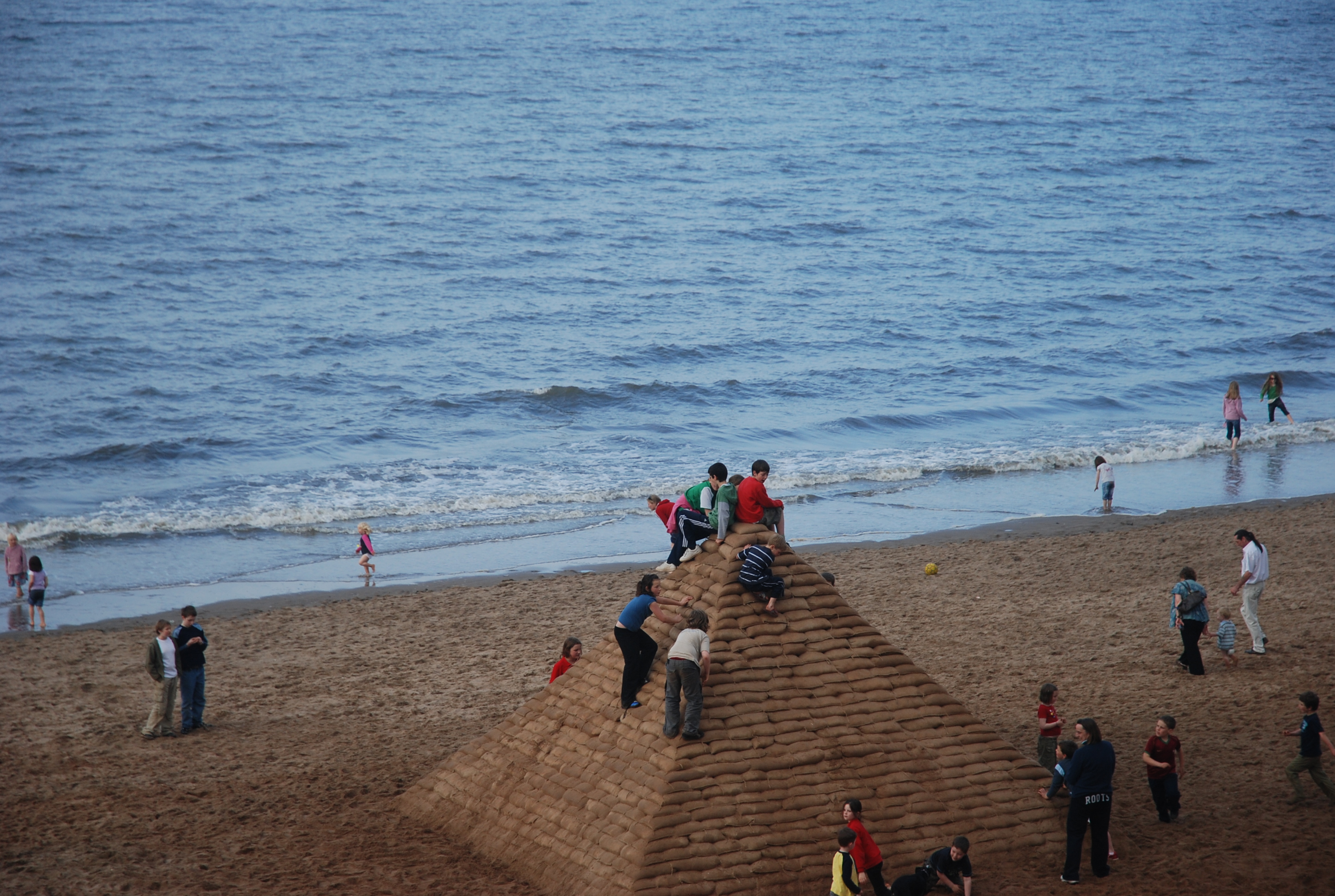 picture of people climbing on a pyramid